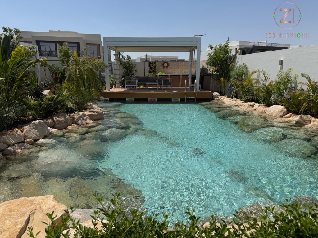 Freeform lagoon pool with natural stone edges and curved design in Dubai villa