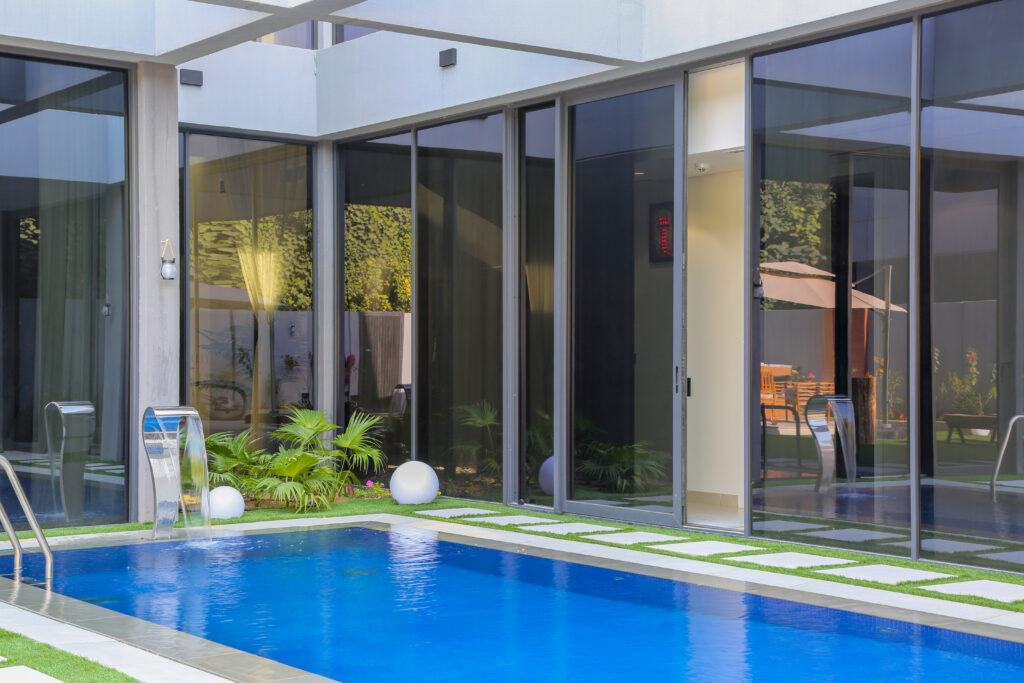 Villa pool with built-in sun deck and natural stone edges
